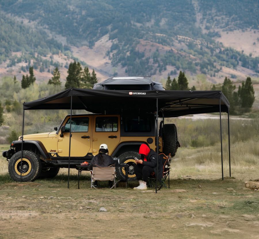 OPENROAD 270° Plus Awning creating extra large shaded space for two people camping under Jeep in mountains