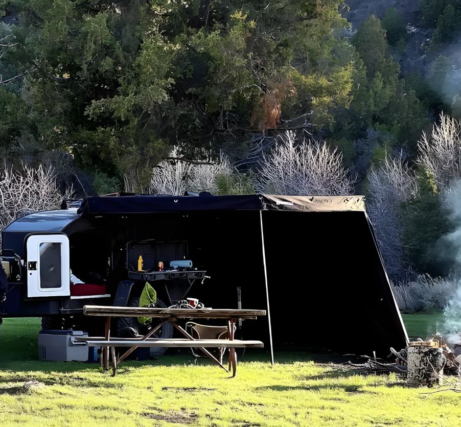 Rear view of OPENROAD 270 awning side walls with open door providing privacy and ventilation for van camping